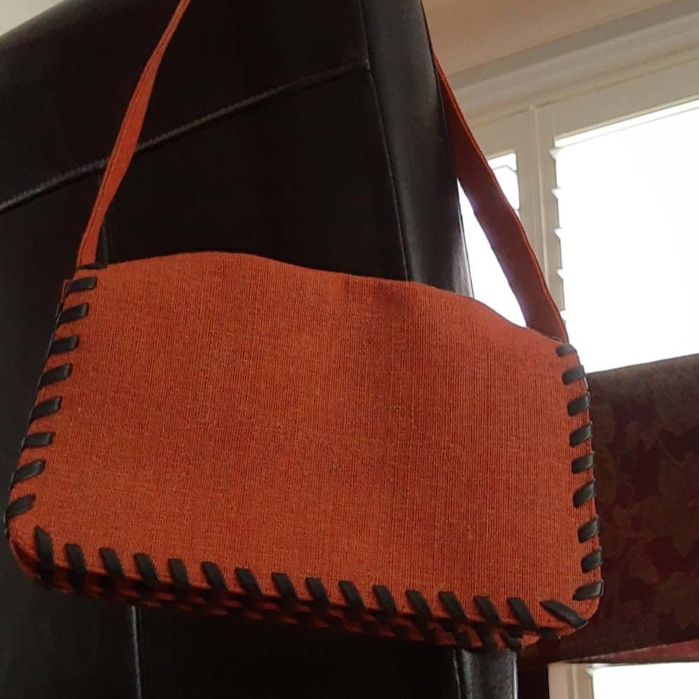 Cute small orange purse with black stitching